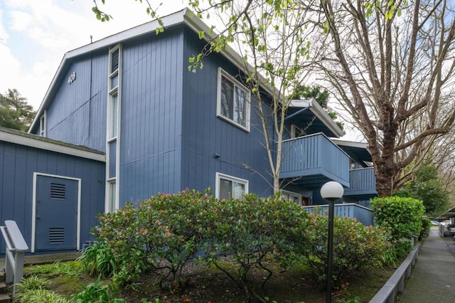 view of side of property with a balcony