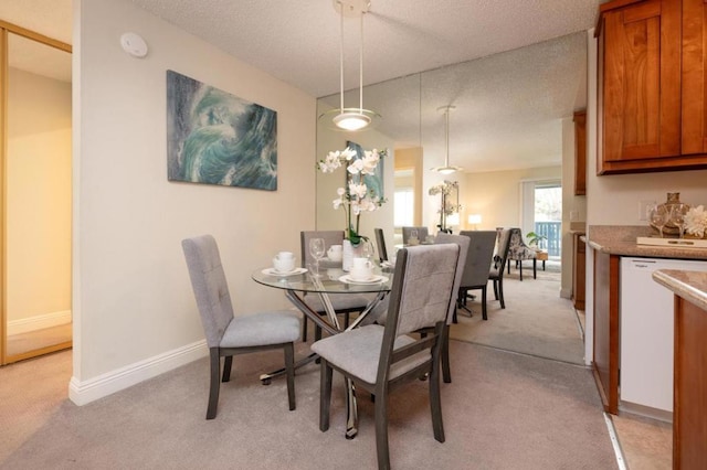 carpeted dining room featuring a textured ceiling