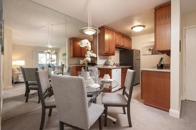 carpeted dining space featuring sink and a textured ceiling