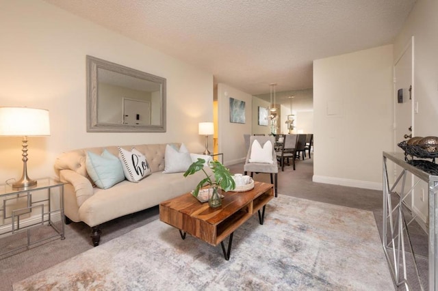 living room with a textured ceiling and carpet flooring