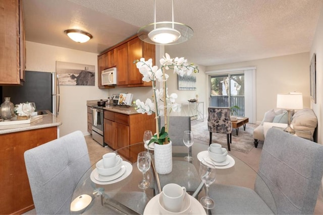 dining space featuring a textured ceiling