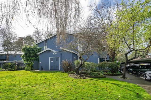 view of property exterior featuring a carport and a yard