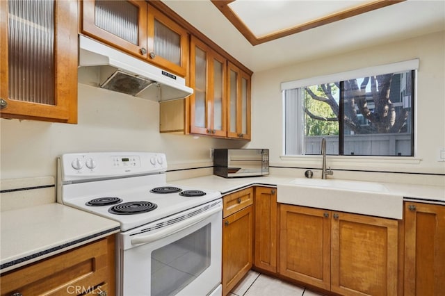 kitchen with sink, electric range, and light tile patterned floors