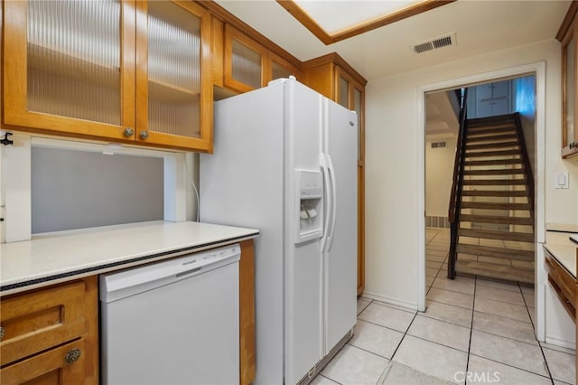 kitchen with white appliances and light tile patterned flooring