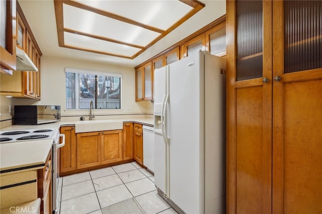 kitchen with sink, light tile patterned floors, and white appliances