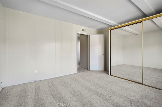 unfurnished bedroom with a closet and carpet flooring