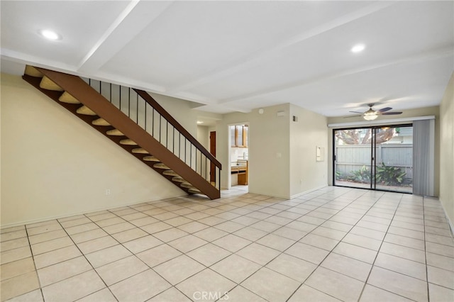 tiled spare room with ceiling fan