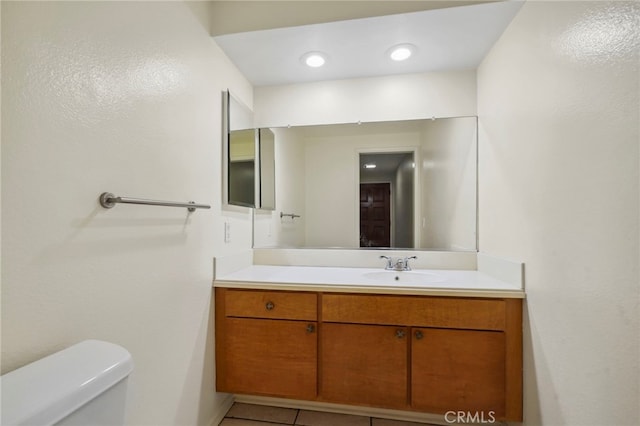 bathroom with vanity, tile patterned floors, and toilet