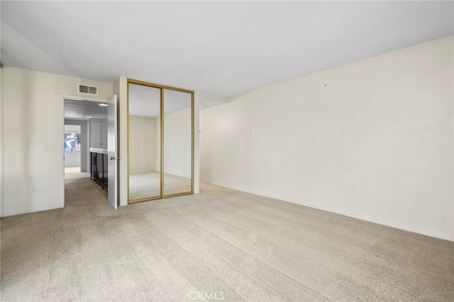 unfurnished bedroom featuring carpet floors and a closet