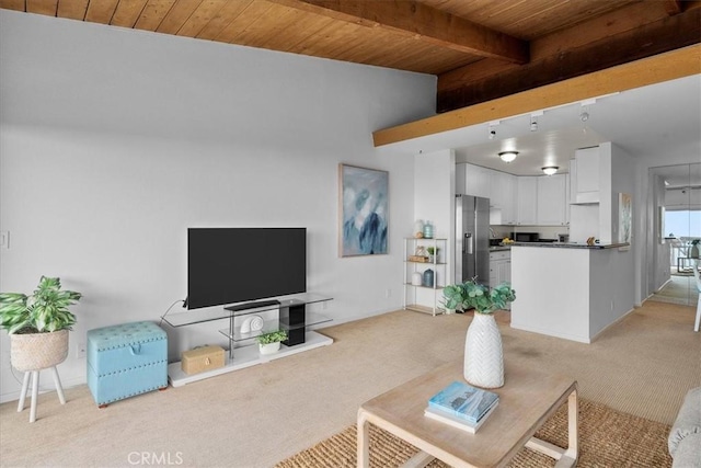 carpeted living room with beam ceiling and wooden ceiling