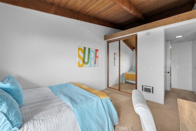 carpeted bedroom with vaulted ceiling with beams, wooden ceiling, and a closet