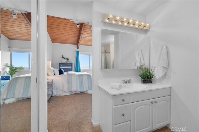 bathroom with a shower with door, vanity, vaulted ceiling with beams, and wooden ceiling