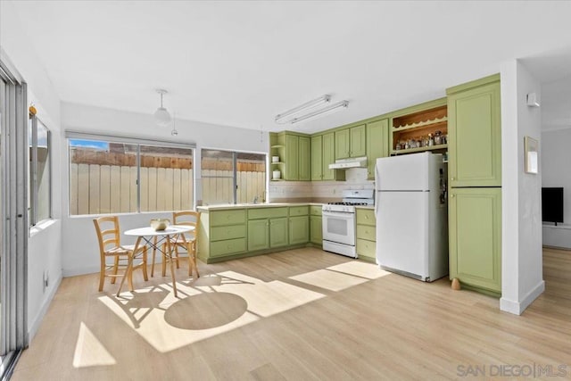 kitchen with sink, white appliances, light hardwood / wood-style flooring, and green cabinetry