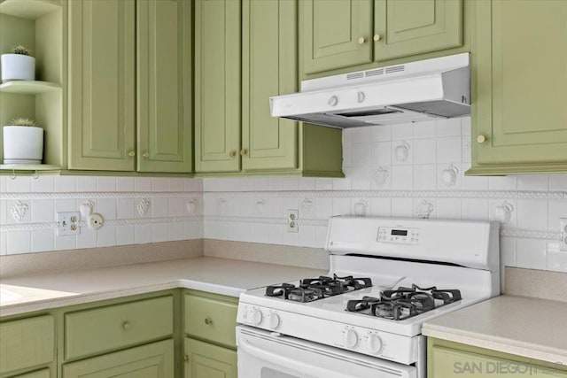 kitchen with tasteful backsplash, gas range gas stove, and green cabinets