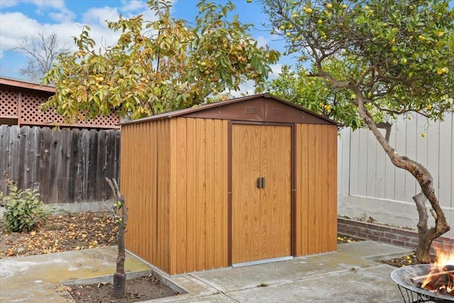 view of outbuilding featuring a fire pit