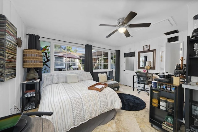 bedroom featuring a ceiling fan, attic access, and visible vents