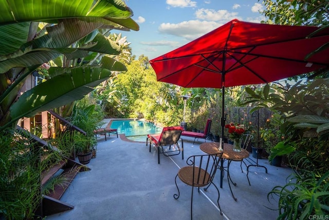 view of patio / terrace with fence and an outdoor pool