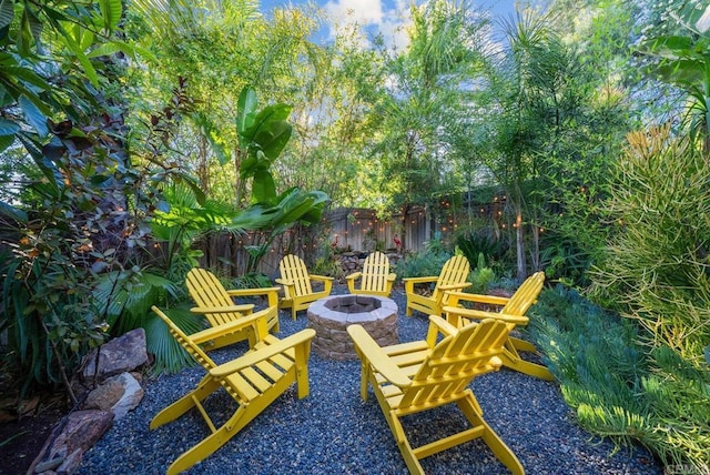 view of patio featuring fence and a fire pit