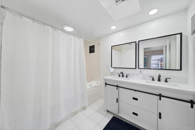 bathroom featuring shower / bath combo, double vanity, tile patterned flooring, and a sink