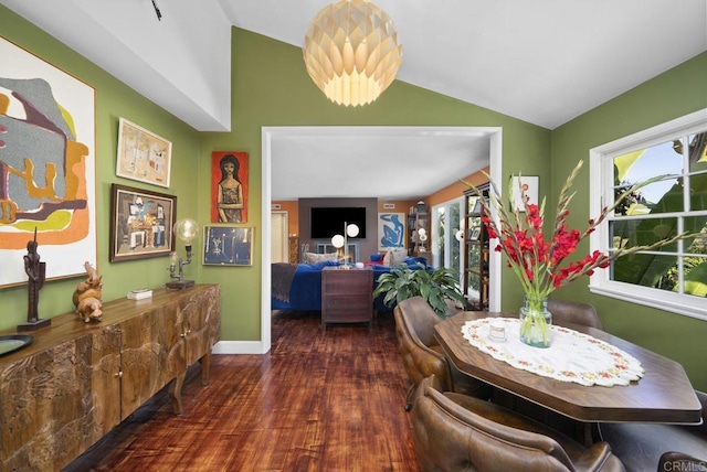 dining area with lofted ceiling, dark wood-style floors, and baseboards