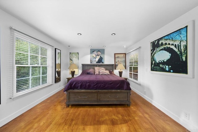 bedroom featuring light wood-type flooring, baseboards, and recessed lighting