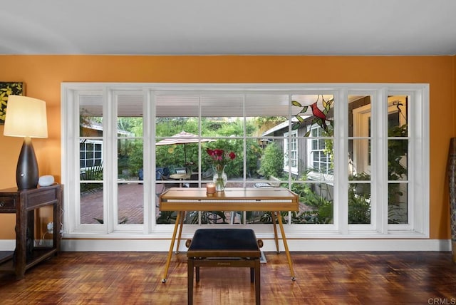 doorway featuring dark wood-style floors and a wealth of natural light