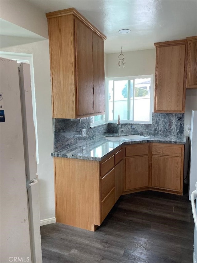 kitchen featuring dark hardwood / wood-style flooring, sink, decorative backsplash, and white refrigerator