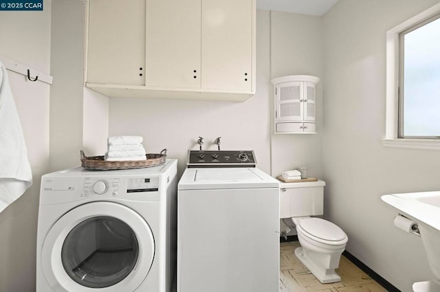 washroom with washing machine and clothes dryer