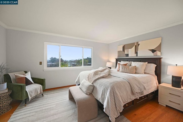 bedroom with crown molding and light hardwood / wood-style floors