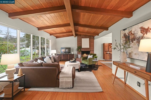 living room with a brick fireplace, vaulted ceiling with beams, wooden ceiling, and light wood-type flooring