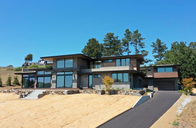 modern home featuring a garage and a balcony