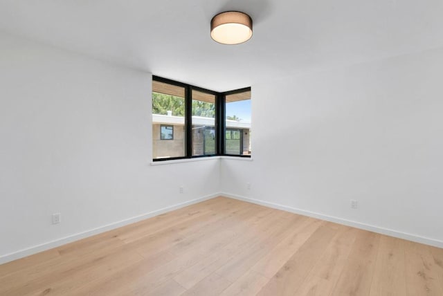 unfurnished room with light hardwood / wood-style floors