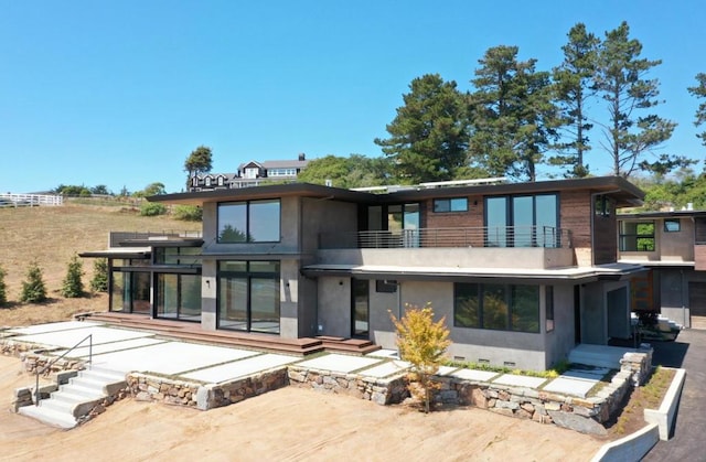 rear view of property with a balcony