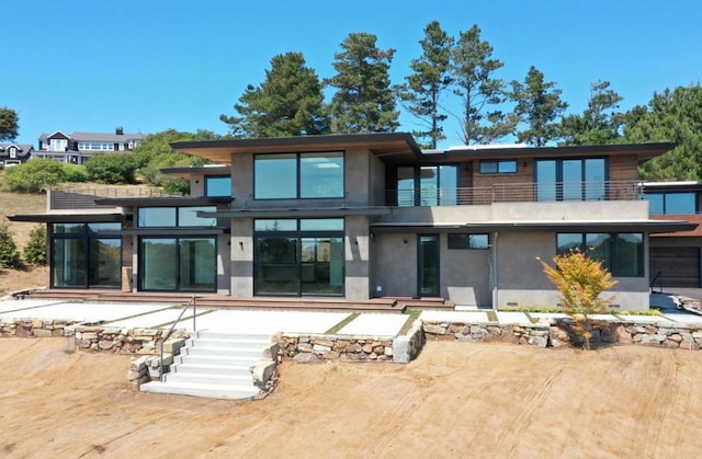 back of property featuring a balcony