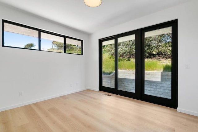 spare room with light hardwood / wood-style flooring