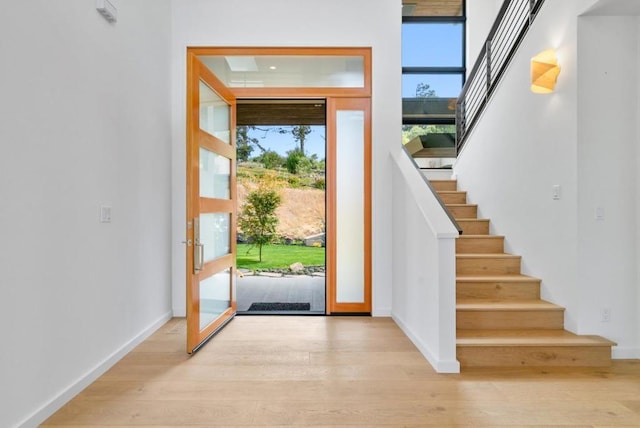 foyer entrance with light hardwood / wood-style floors