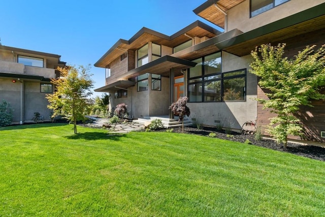 rear view of property featuring a yard