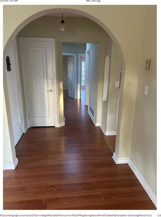 corridor with dark hardwood / wood-style floors