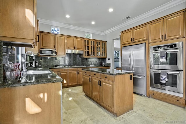 kitchen with tasteful backsplash, a center island, dark stone countertops, ornamental molding, and appliances with stainless steel finishes