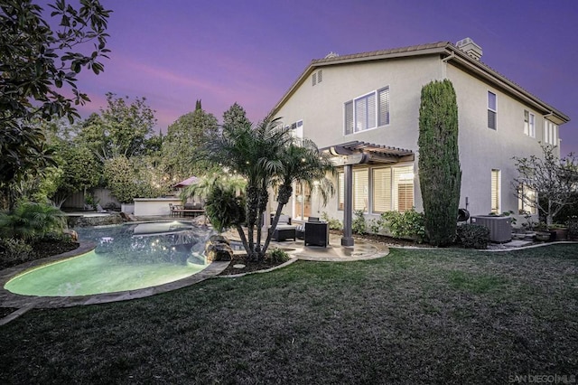 back house at dusk featuring cooling unit, a pergola, a patio, and a lawn