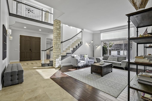 living room with crown molding, decorative columns, and light hardwood / wood-style floors