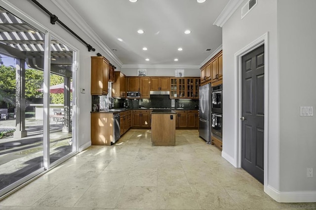 kitchen featuring sink, crown molding, a center island, stainless steel appliances, and decorative backsplash