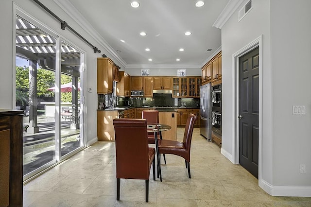 dining room featuring ornamental molding, sink, and light tile patterned flooring