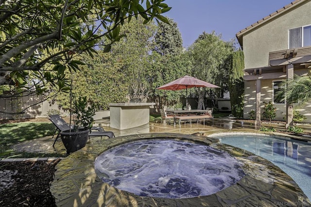 view of pool with a patio and an in ground hot tub