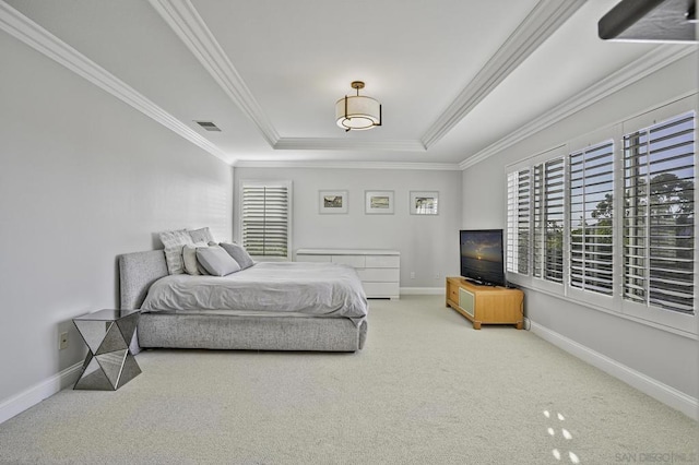 carpeted bedroom with a raised ceiling and ornamental molding