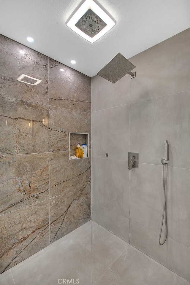 bathroom with tiled shower