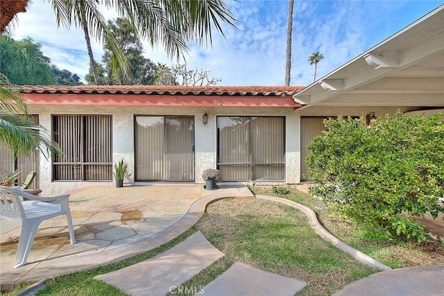 back of property with a patio