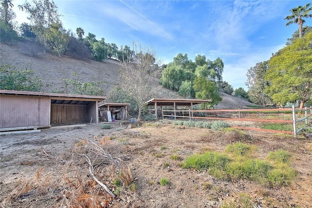 exterior space featuring an outbuilding and a rural view