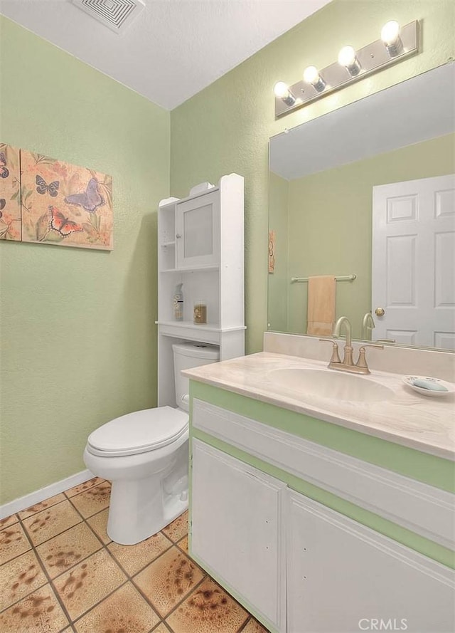 bathroom featuring vanity, toilet, and tile patterned flooring