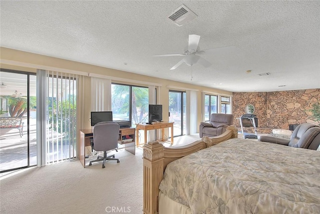 bedroom featuring light carpet, access to outside, and a textured ceiling